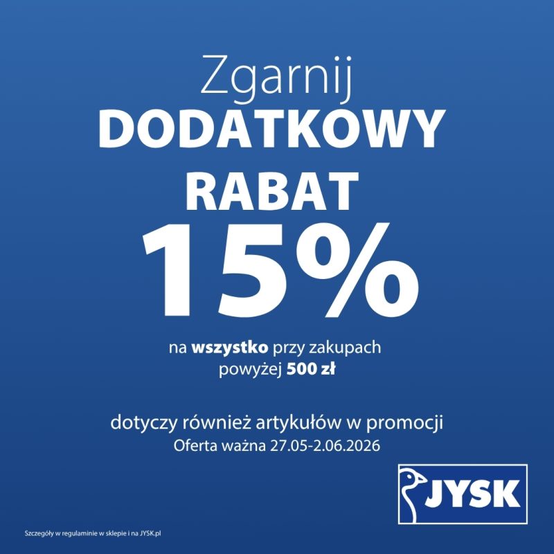 Grafika reklamowa sieci JYSK przedstawia informację o promocji na jednolitym, niebieskim tle. Centralną część zajmuje duży, biały napis „Zgarnij DODATKOWY RABAT 15% na wszystko przy zakupach powyżej 500 zł”, a w prawym dolnym rogu umieszczono charakterystyczne logo marki z gęsią.