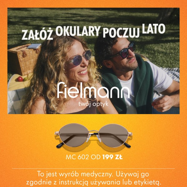 Grafika reklamowa przedstawia uśmiechniętą parę w okularach przeciwsłonecznych, odpoczywającą na kocu piknikowym w ogrodzie, z dużym napisem „ZAŁÓŻ OKULARY POCZUJ LATO” oraz logo Fielmann. W dolnej, pomarańczowej części widoczne jest zdjęcie okularów w cienkiej oprawce z ceną od 199 zł oraz wymagane prawnie ostrzeżenie dotyczące wyrobu medycznego.